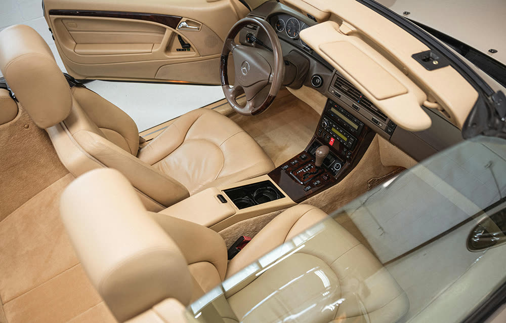 Top-view of a spotless beige convertible interior featuring leather seats and polished console, freshly serviced through interior car detailing Toronto. Ideal example of meticulous interior car cleaning Toronto for luxury vehicles.