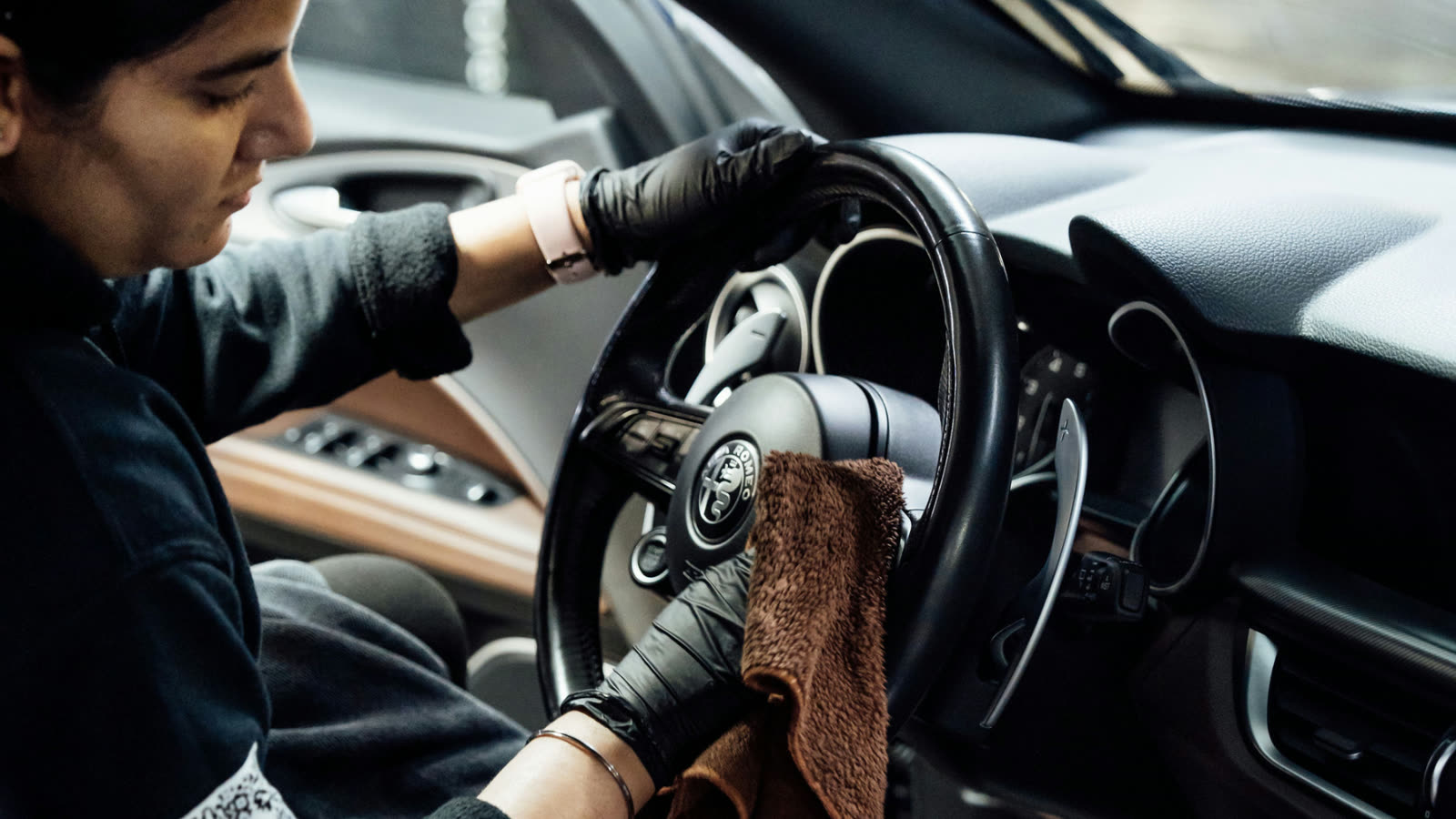 Interior detailing with microfiber cleaning steering wheel at ALPHASHINE Toronto, professional car detailing service