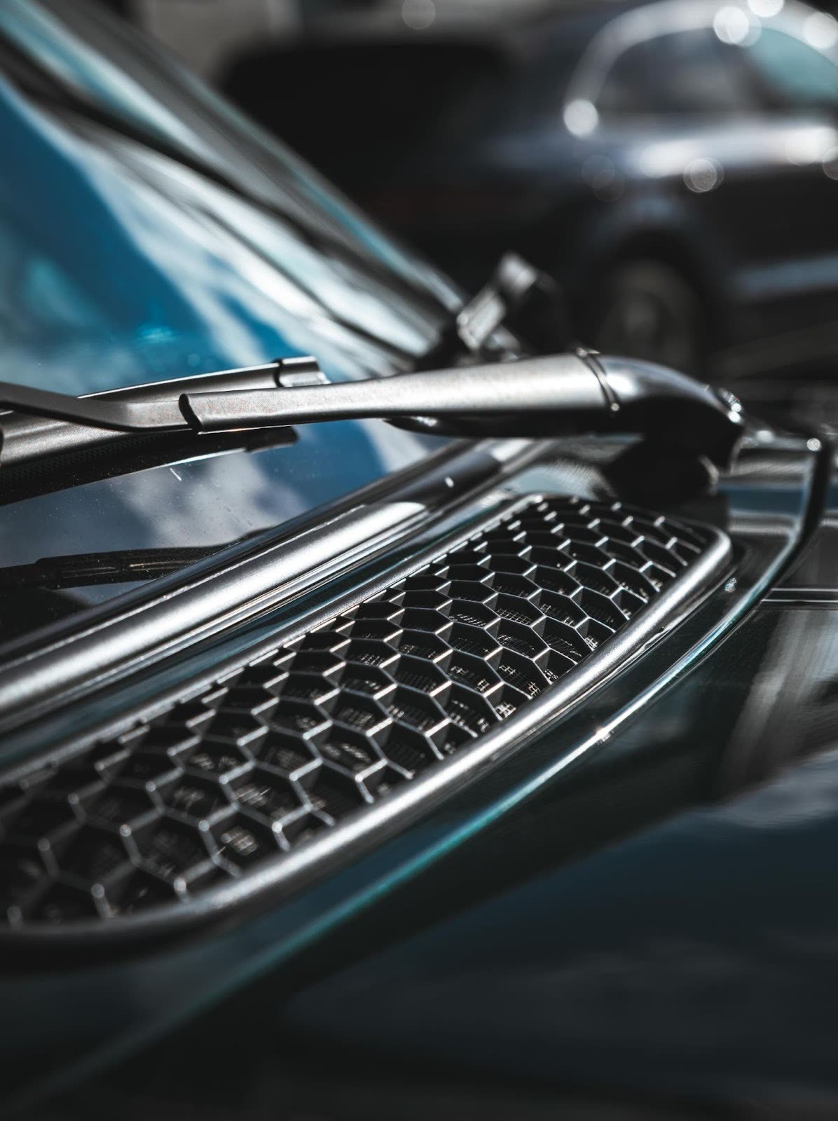 Close-up of a clean car windshield and black grille after exterior polishing during a professional Toronto auto detailing session by Alphashine.