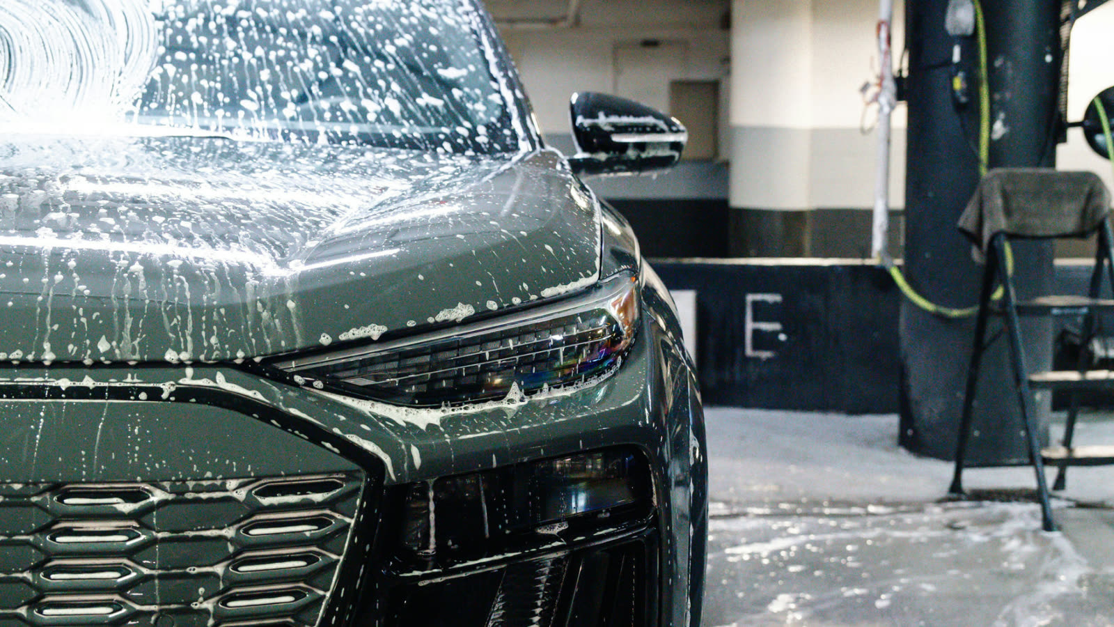 Car covered in foam during hand wash at ALPHASHINE, professional exterior detailing in Toronto