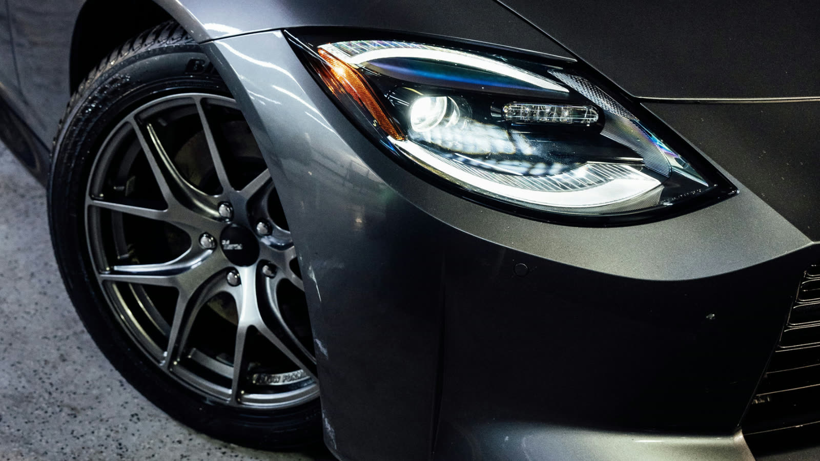 Close up of headlight and wheel after detailing at ALPHASHINE, exterior car detailing service in Toronto