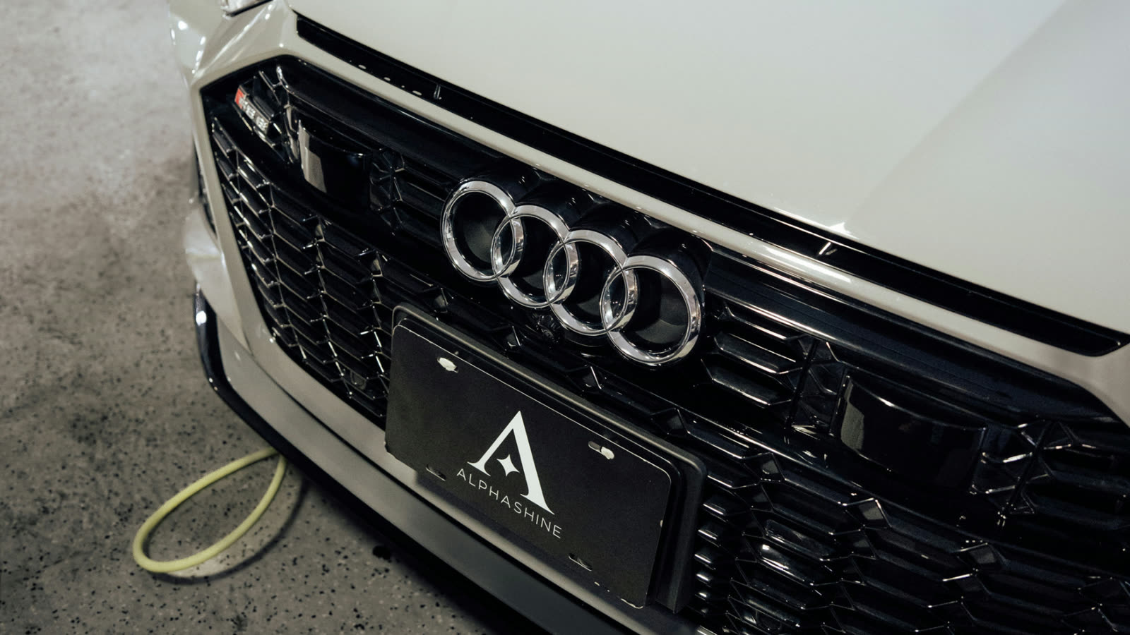 Audi front grille close up with ALPHASHINE plate, premium car detailing in Toronto