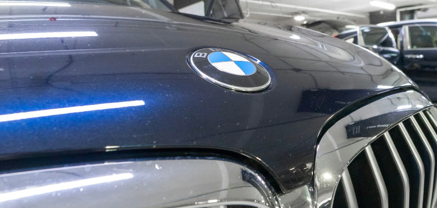 Dusty BMW hood and grille before premium service from ALPHASHINE Car Detailing in City Place, Toronto.