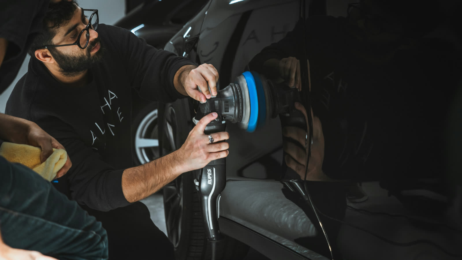 Professional car paint correction process performed by an auto detailing expert, showcasing car detailing paint correction near me with precision polishing to restore paint clarity.