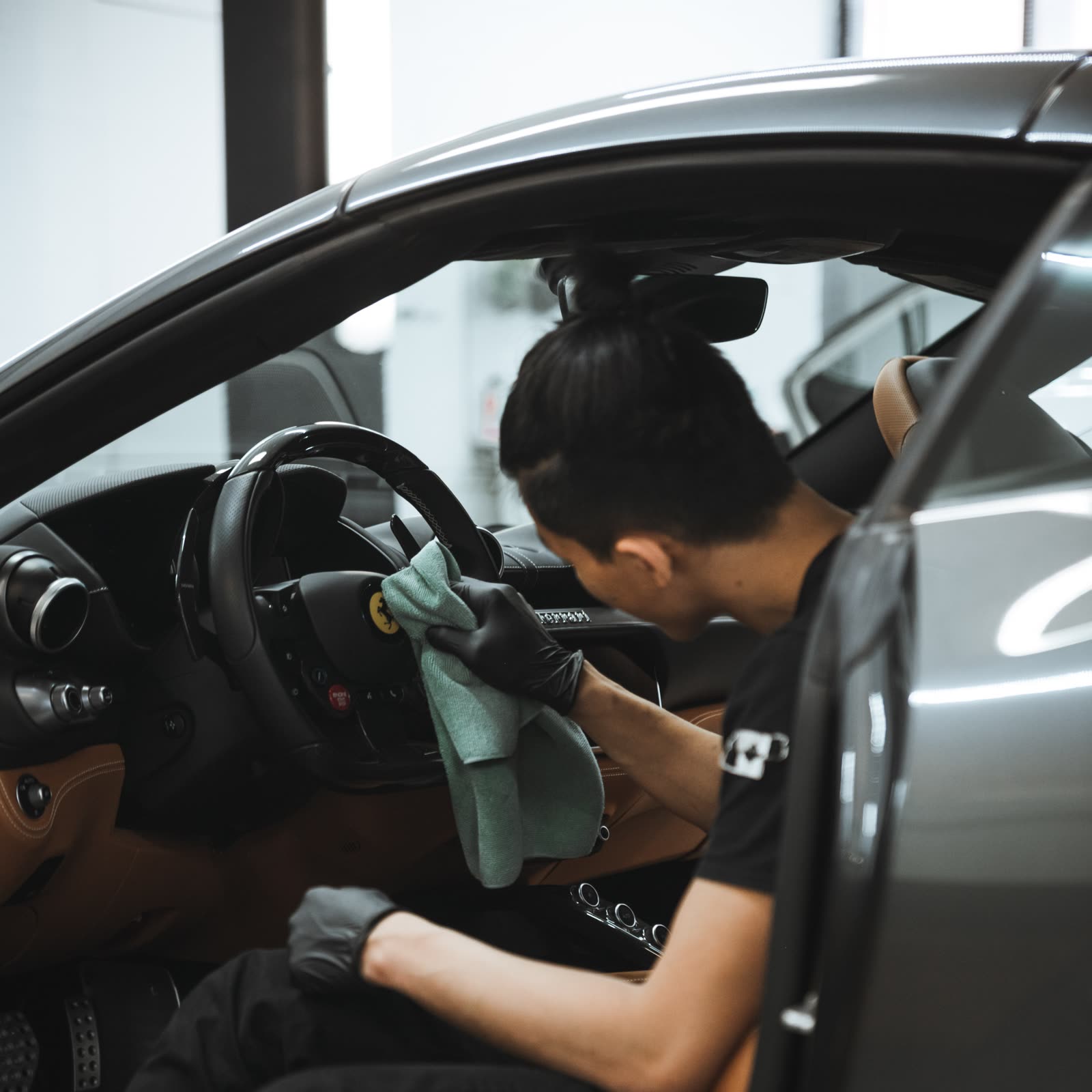 alphashine employee cleaning interior car steering wheel