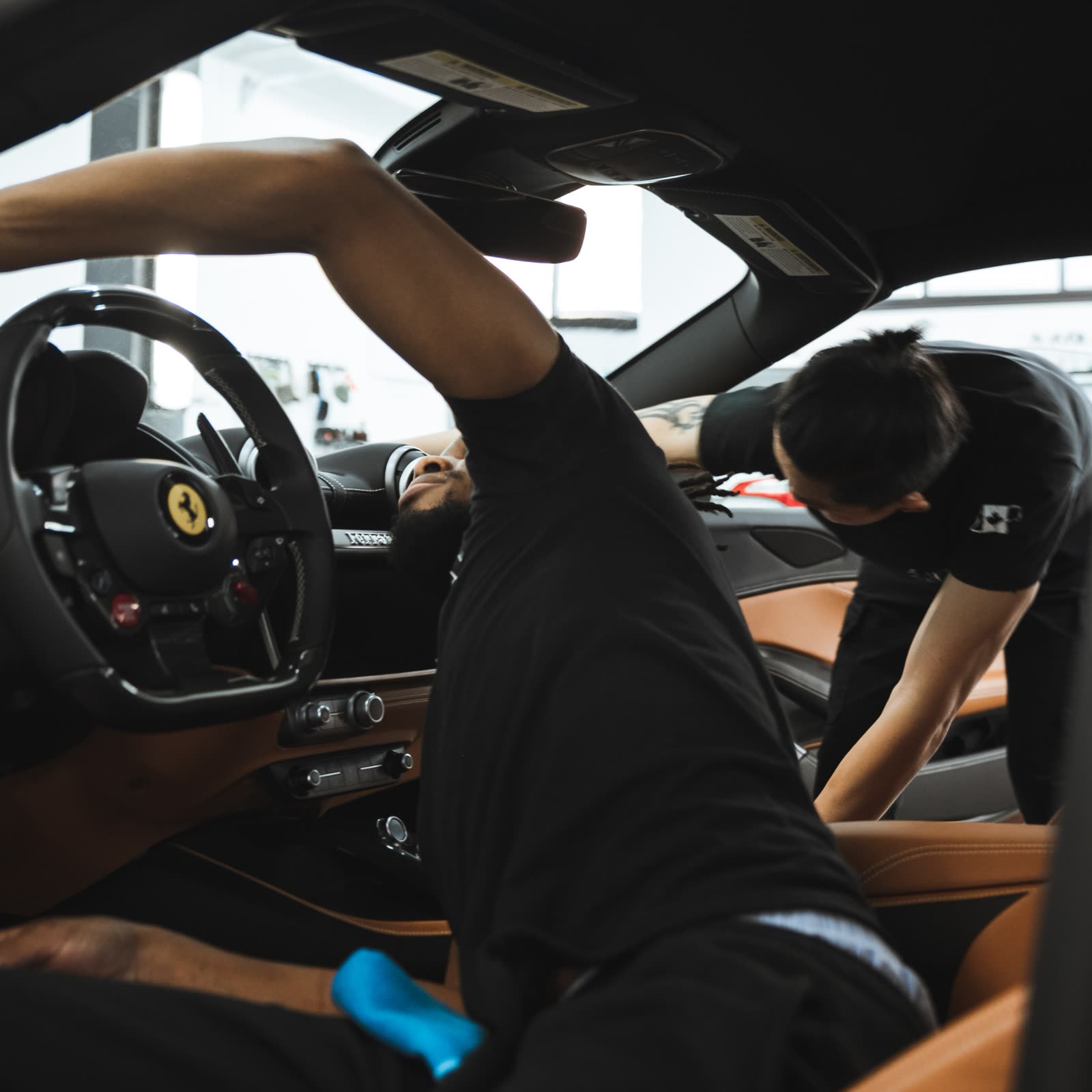 detailers working on the interior of a vehicle