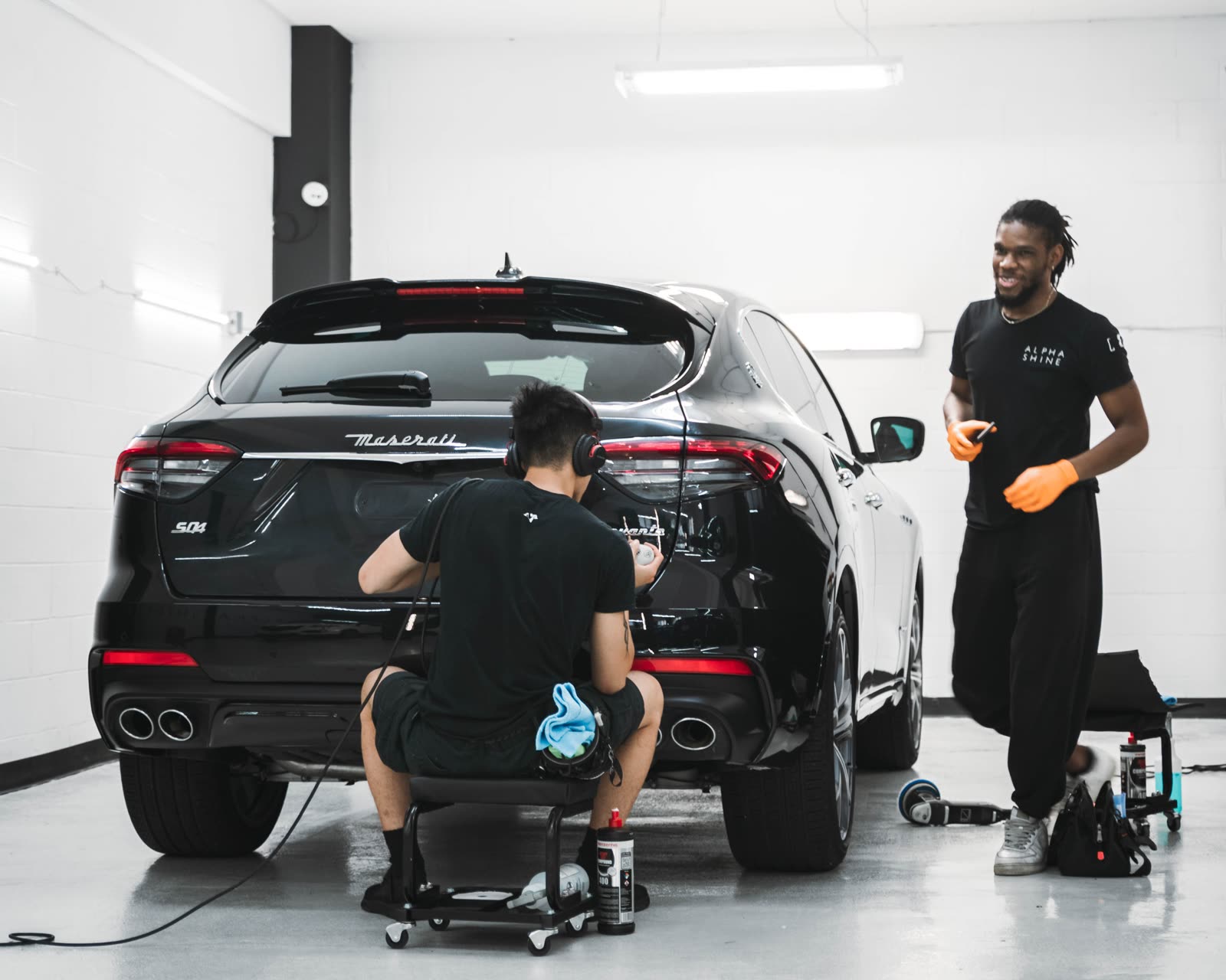 Team members detailing a car